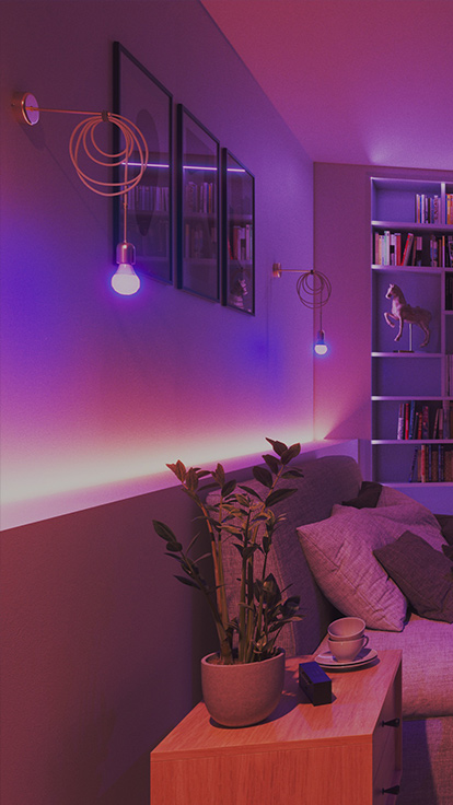 Đây là hình ảnh Bóng đèn Nanoleaf Essentials A19 được lắp đặt trong phòng ngủ Đèn chiếu sáng được gắn trên tường phía sau giường ngủ. Với dài màu phát sáng gồm hơn 16 triệu màu, bóng đèn LED thay đổi màu sắc thông minh là thiết bị lý tưởng để thiết lập không gian hoàn hảo trong phòng ngủ.