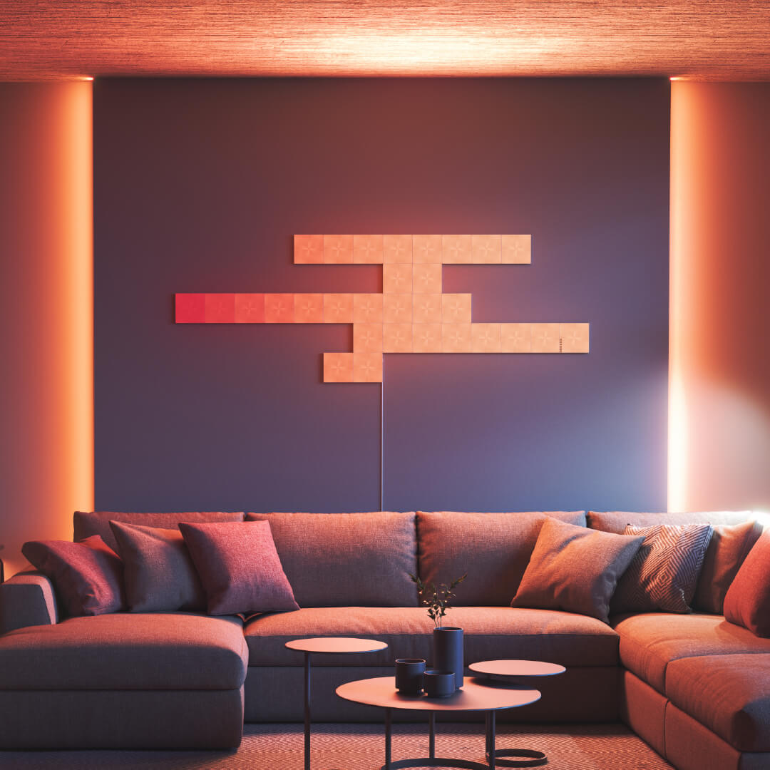 Ô đèn thông minh dạng môđun hình vuông có thể thay đổi màu sắc Nanoleaf Canvas được gắn lên tường trong phòng khách. Tương tự với Philips Hue, Lifx. HomeKit, Trợ lý Google, Amazon Alexa, IFTTT. 