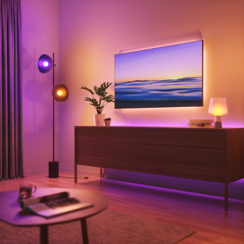 Nanoleaf Essentials Thread enabled color changing smart light bulbs mounted to fixtures in a living room. Similar to Wyze. HomeKit, Google Assistant, Amazon Alexa, IFTTT.
